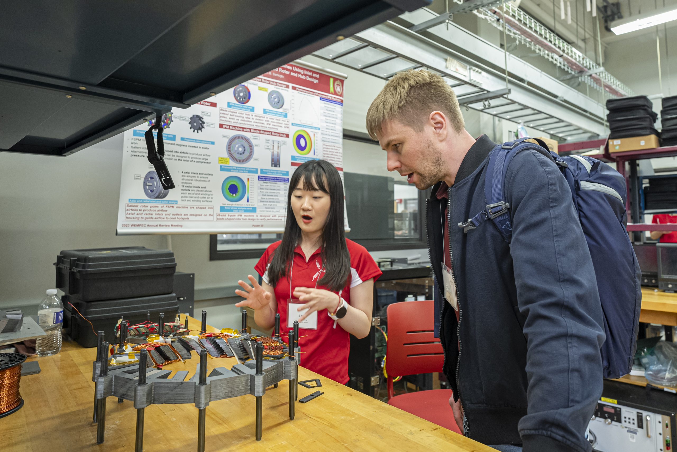 A WEMPEC student explaining their project to a member company representative.