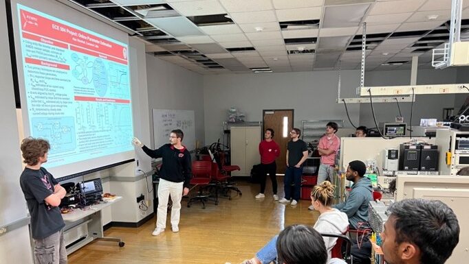Two students during their ECE 504 final project presentation - the tasks was to implement a specific electric machine control algorithm of the students' choice